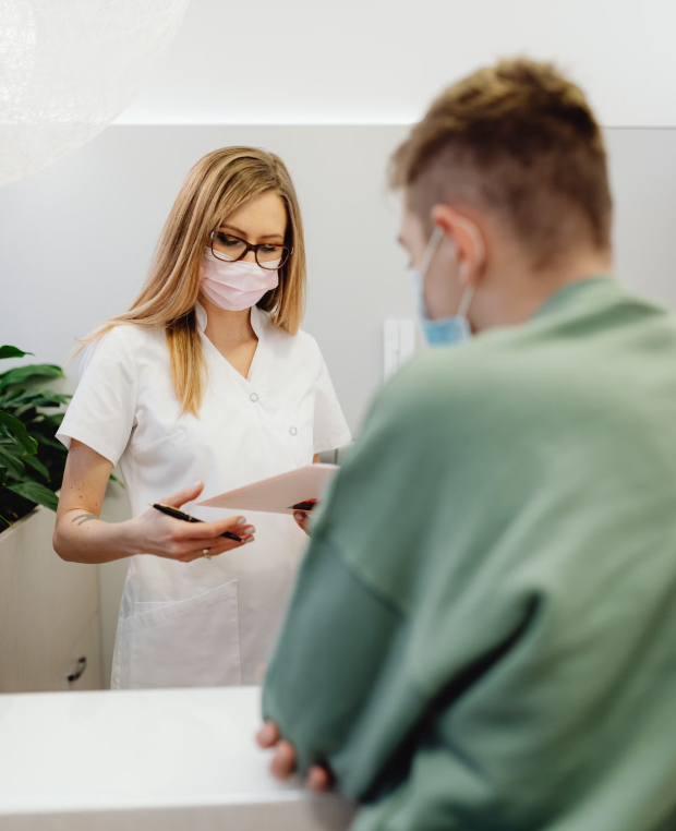 Medical staff assisting patients at a healthcare reception desk